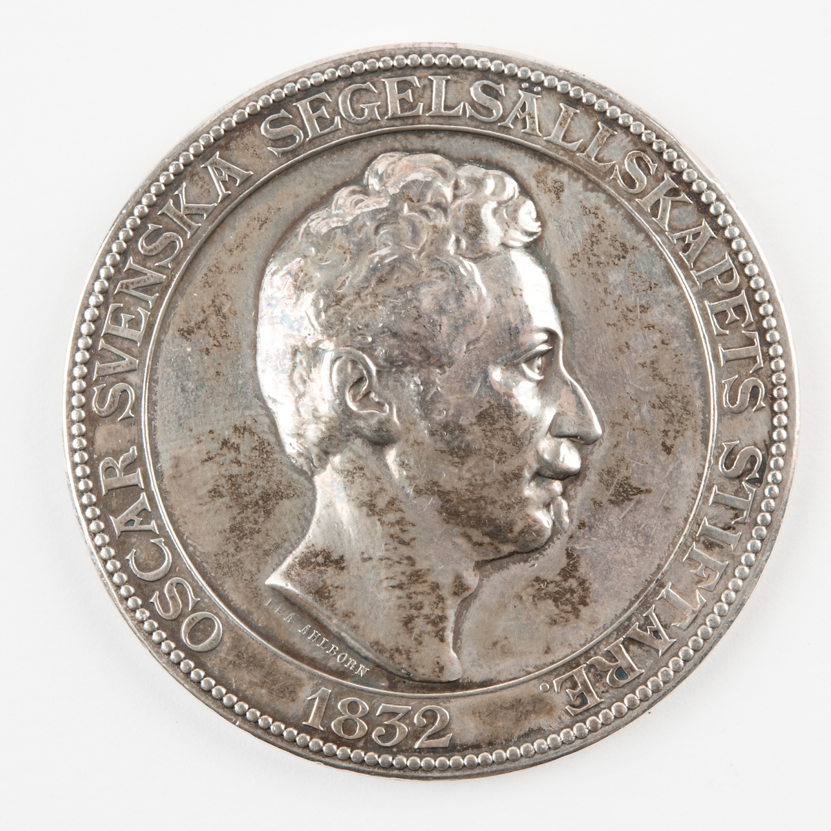 Frånsidan: Neptunus står på havet med sin treudd i vänstra handen och i den högra en krans av lager, seende på en framilande kutter.

Konstnär: Ahlborn, Lea Fredrika, 1826-1897