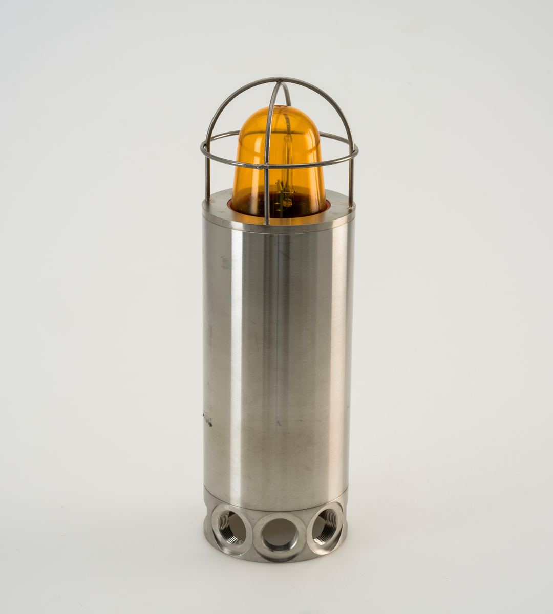 Sylinderformet signallampe av rustfritt stål med kuppel av plast. Lampen er ubrukt.
