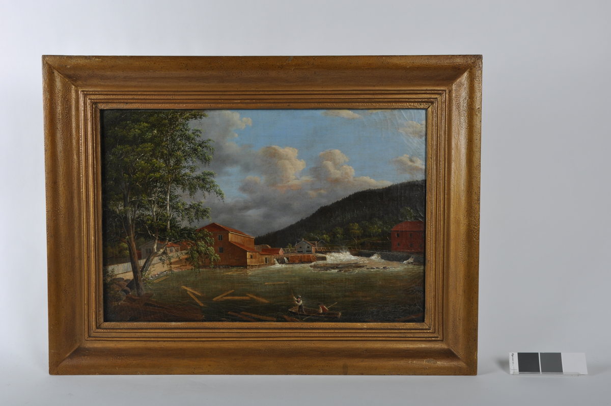 På maleriet ser vi Skåningsfossen i Tista, sett fra sør. Tista delte de to tidligere kommunene Berg (til venstre) og Idd (til høyre). Den store, gule bygningen til venstre er kjøpmann Wilhelm Hansens mølle. Han var en av Fredrikshalds mektigste menn. Til venstre for mølla ser vi møllemesterboligen og en arbeiderbolig for møllearbeiderne samt noen uthus. Til høyre for mølla ser vi Hansens sag, og helt til høyre i bildet ser vi mølla til Peter Anker og Christen Stang.