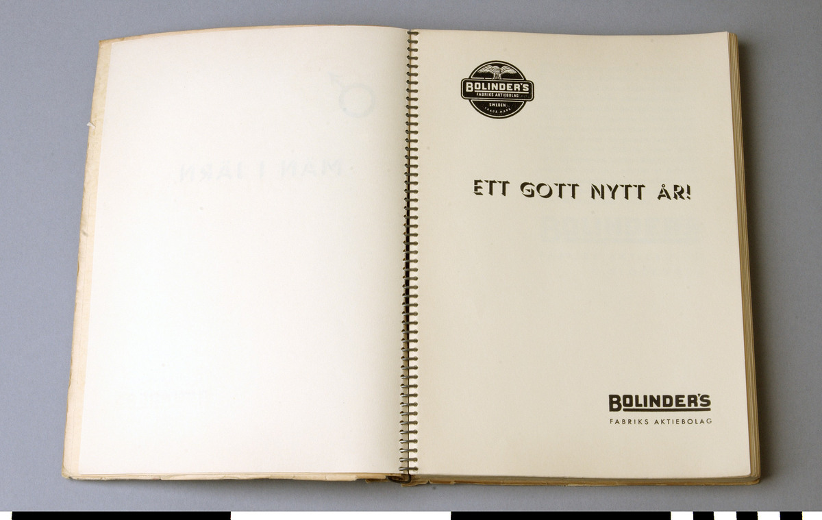 Årsbok, 4 st, med karikatyrer av olika järnhandlare. Titel: MÄN I JÄRN utgiven av Bolinders Fabriks Aktiebolag. Spiralbindning.
A: DEL I  1935-1936.
B: DEL II 1936-1937.
C: DEL III 1937-1938.
D: DEL IV 1938-1939. Tunnare än de andra delarna. Djup= 10 mm.

Funktion: Årsvis återblick eller sammanställning, ofta använd som minnesgåva