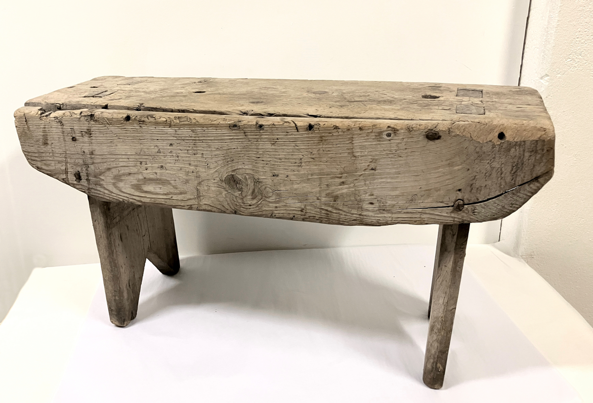 Målselv: Lundberg: Klasrommet: Trebenk: plank som sitte-/benkflate med plank på hver ende som føtter. Disse er felt inn i benkflata. Nederst skåret ut vinkelstykke som gir 4 føtter. På ene siden festet/spikret en plank med bue på undersiden, som låser konstruksjonen. Umalt.