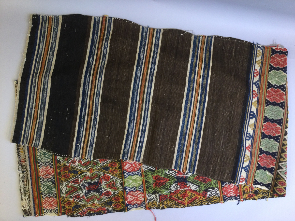 Åkdyna, vävd i krabbasnår. Ylle i färger. Linvarp. Baksidan randig.
Inventerat för Fatburen 1970.

Funktion: Komfort och dekoration vid resa