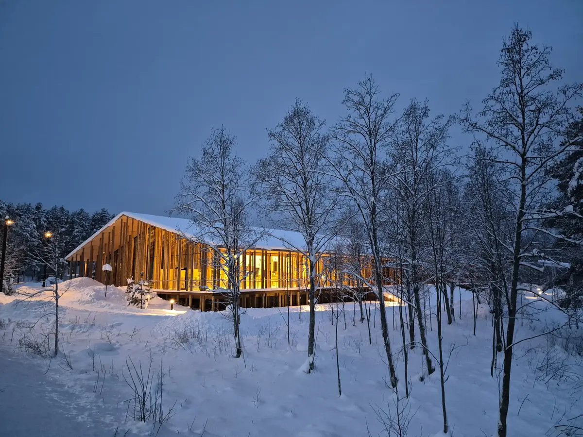Stor trebygning mellom trærne.
