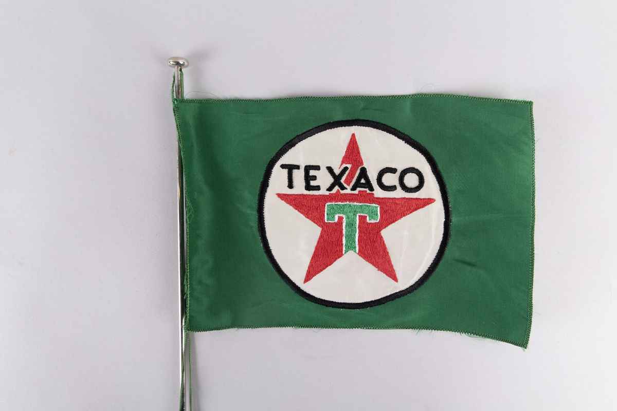 Motiv av skorsteinsmerke til rederiet Texaco Norway AS med bokstaven  T samt tekst TEXACO