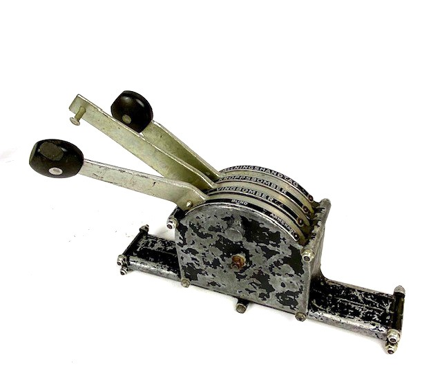 Bombväljare i metall, svartmålad. Tre spakar för val av fällningshandtag, kroppsbomber eller vingbomber -  säkrad, blind, armerad. Bakelitknopp på handtagen.