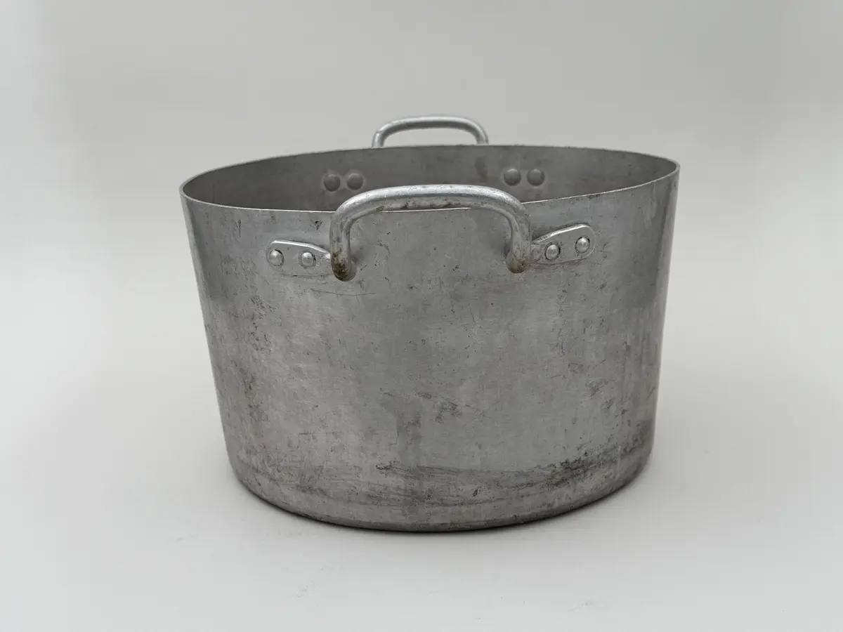 Rund kastrull av metall med två våggrepar. Stämplad Skultuna 1607 under krona samt 8L.