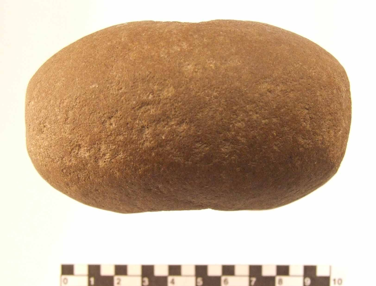 Klubba av granit. Klotfomig med ovalt tvärsnitt. Genomborrad med ett bikoniskt hål 10-35 mm diameter. Slagytor på båda kortändarna.