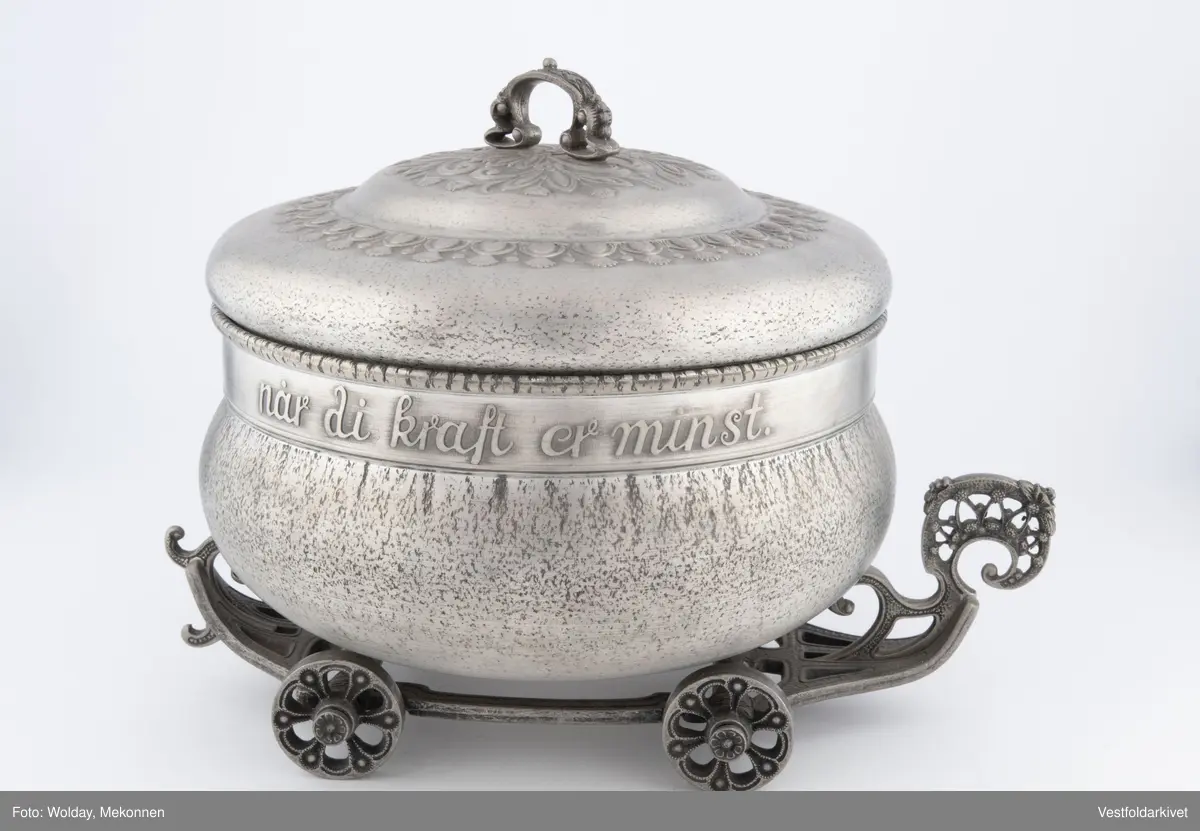 En terrin med lokk. Den har hjul slik at den kan "kjøre" bortover bordet.