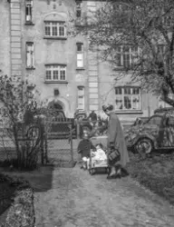 Folk og bilar ved Murboligen i Odda på 1940/1950-talet.