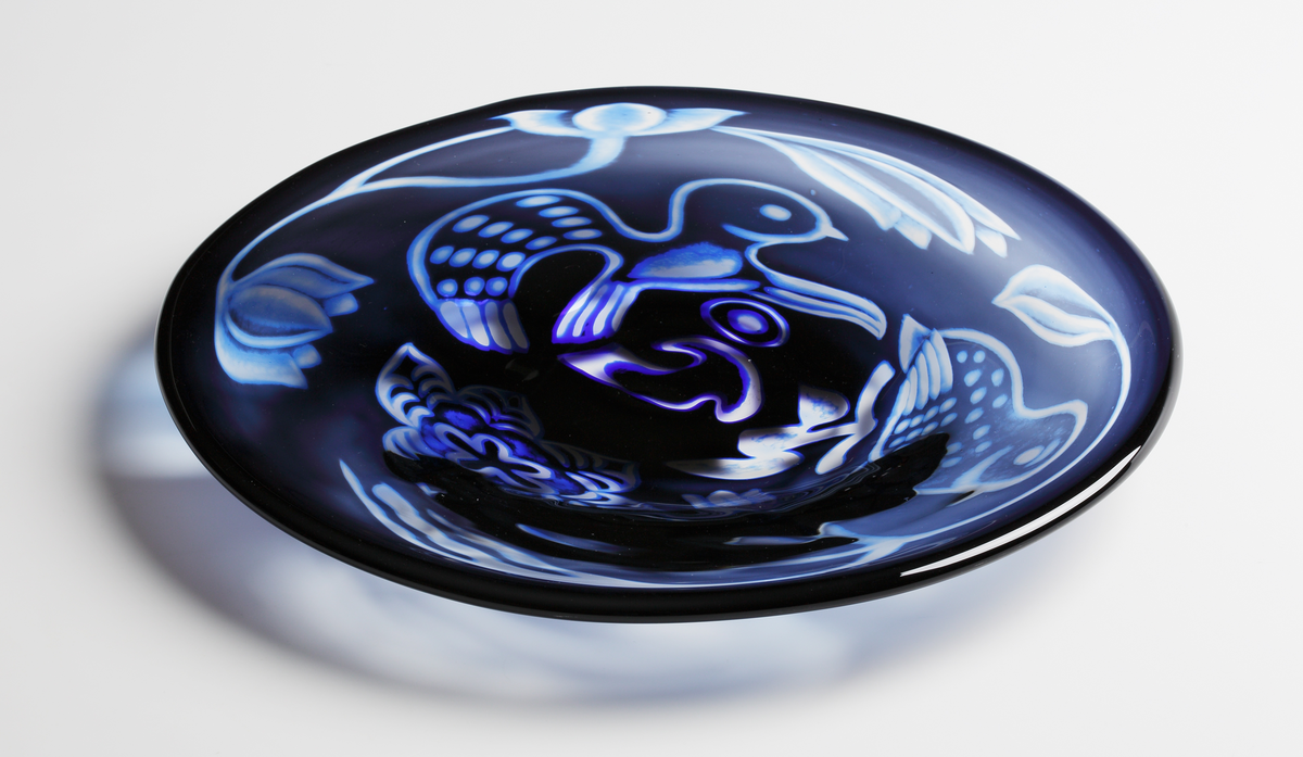 Graalfat, rund form. Dekor i form av två stiliserade fåglar och blommor i dunkelblå nyans.
Formgivare: Eva Englund.