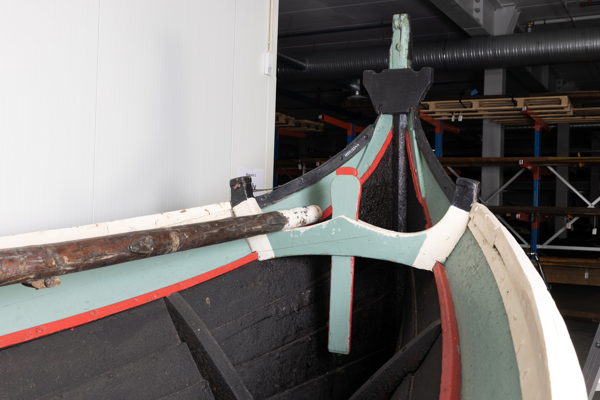 Åttring med løfting. Rødbrunt bunnstoff og tjæret skrog. Øverste bordgang har bredere grønt felt og smalere hvitt og rødt felt.