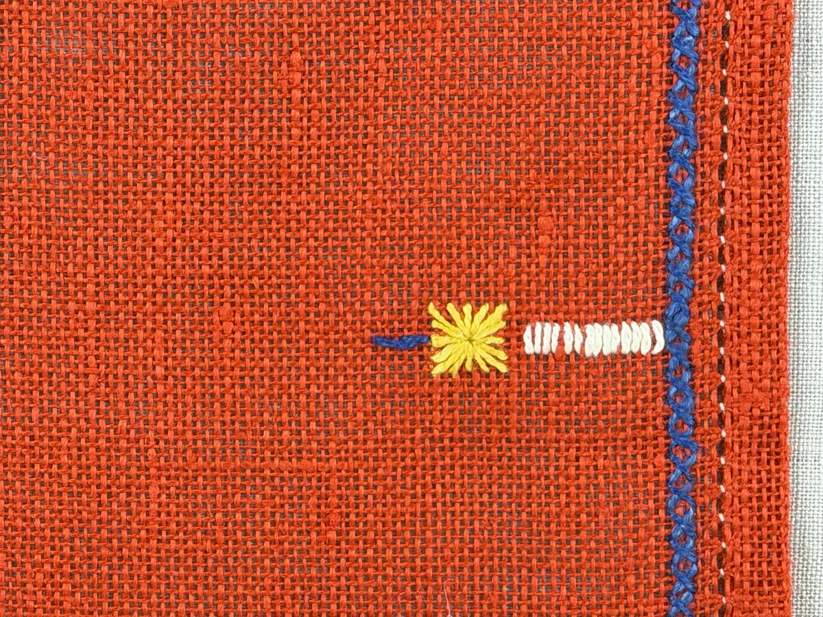 Jullöpare gjord av linneväv med 7tr/cm i tuskaft och broderi utfört med lingarn i stjälksöm, rutsöm, plattsöm samt korsstygn. 
Löparen är inramad med en korsstygns rad och kanterna har 9mm breda fållar runt om fastsydda med en halv hålsöm plus sneda hörn, vilka är sydda med kaststygn. 