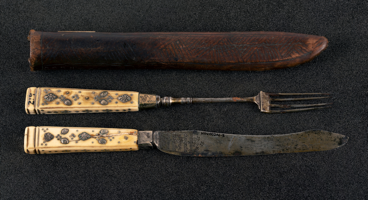 Kniv med beinskaft med metallpryd, blad med inskripsjoner.