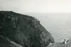 Tandläkare Gunnar Högberg ligger vid foten av en klippa och blickar ut över havet vid Kullen, Kullaberg i Skåne, 1922.