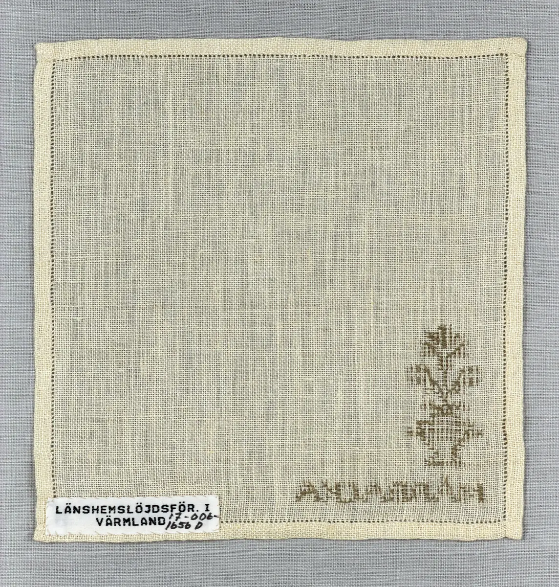 Duk gjord av linneväv med 12tr/cm i tuskaft och broderi utfört med lingarn i korsstygn sydda över två trådar. Duken har 6mm bred dubbelvikt fåll runt om fastsydd med en enkel hålsöm samt raka hörn, vilka är sömmade med kaststygn.
