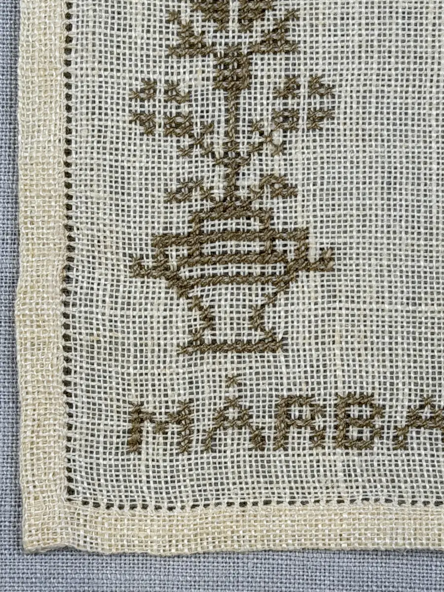 Duk gjord av linneväv med 12tr/cm i tuskaft och broderi utfört med lingarn i korsstygn sydda över två trådar. Duken har 6mm bred dubbelvikt fåll runt om fastsydd med en enkel hålsöm samt raka hörn, vilka är sömmade med kaststygn.
