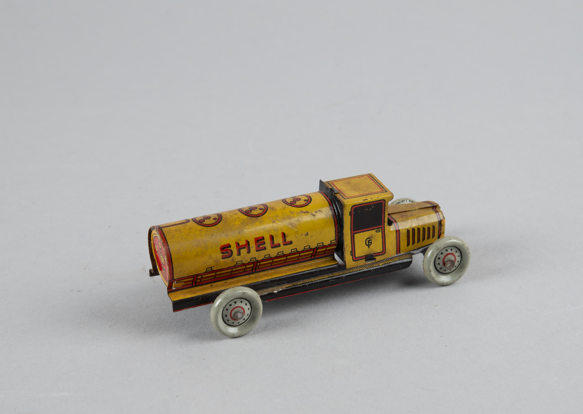 Liten tankbil med fire hjul, for olje/bensin.
