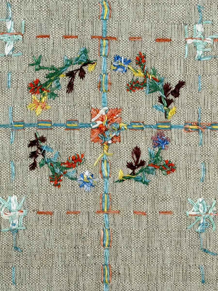 Duk gjord av halvlinne i sålldräll och broderi utfört med lingarn i förstygn, plattsöm och stjälksöm. Duken har 1cm bred dubbelvikt fåll runt om samt sneda hörn, vilka är sydda med kaststygn.