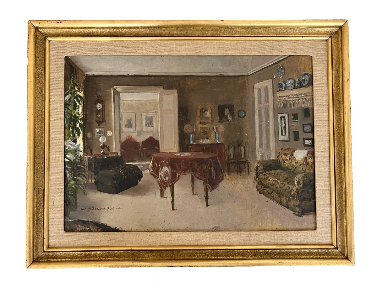 Historisk bild av en rumsinteriör. På golvet ett runt bord som är täckt av en långt nedhängande brokig duk. Längst till höger en pompös plyschsoffa ovan på väggen en tavelgrupp, närmast taket en med tofsar spetsprydd hylla med prydnadsalster bredvid en dörröppning. I bakgrunden till höger en kortvägg med byrå, en stol, prydnader, tavlor. Till vänster en med dubbeldörrar försedd öppning till bakomvarande rum, till vänster därom ett väggur, en möbel, prydnader, närmast blomblad från en växt. Ram: 5,5 cm, förgylld, profilerad, 2,5 cm linneväv i inre kant.