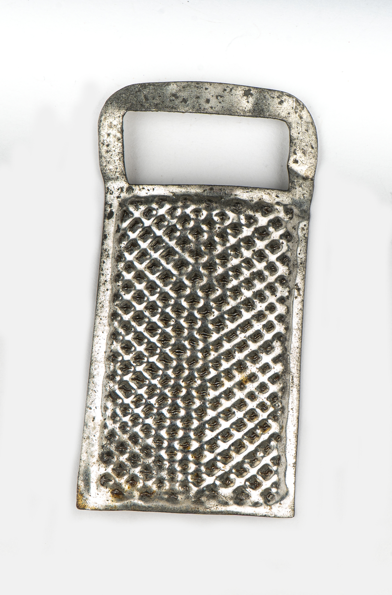 Rivjärn, 1-3, av vitmetall. En rektangulär skiva välvd.
Ytan fylld av rivtaggar. upptill ett format handtag.
1 och 2 är större än 3.

Tillhör leksakssamling GM17037a-k.