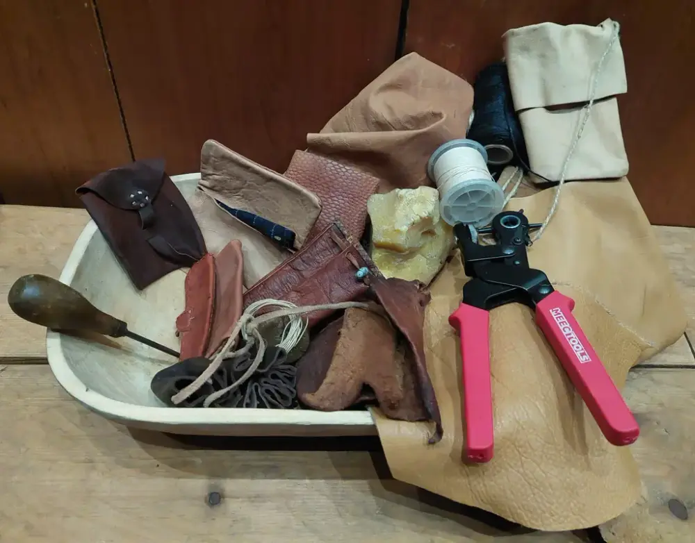 En samling av skinn-rester og forskjellige verktøy for skinn-arbeid.