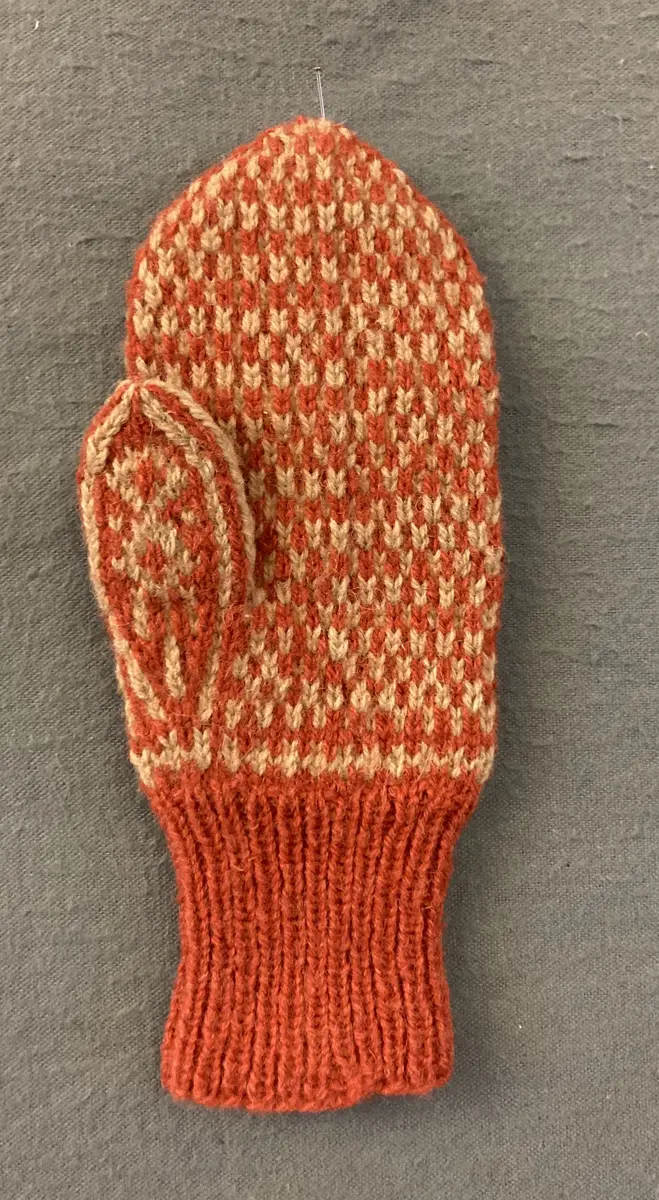 Mönsterstickad barnvante.