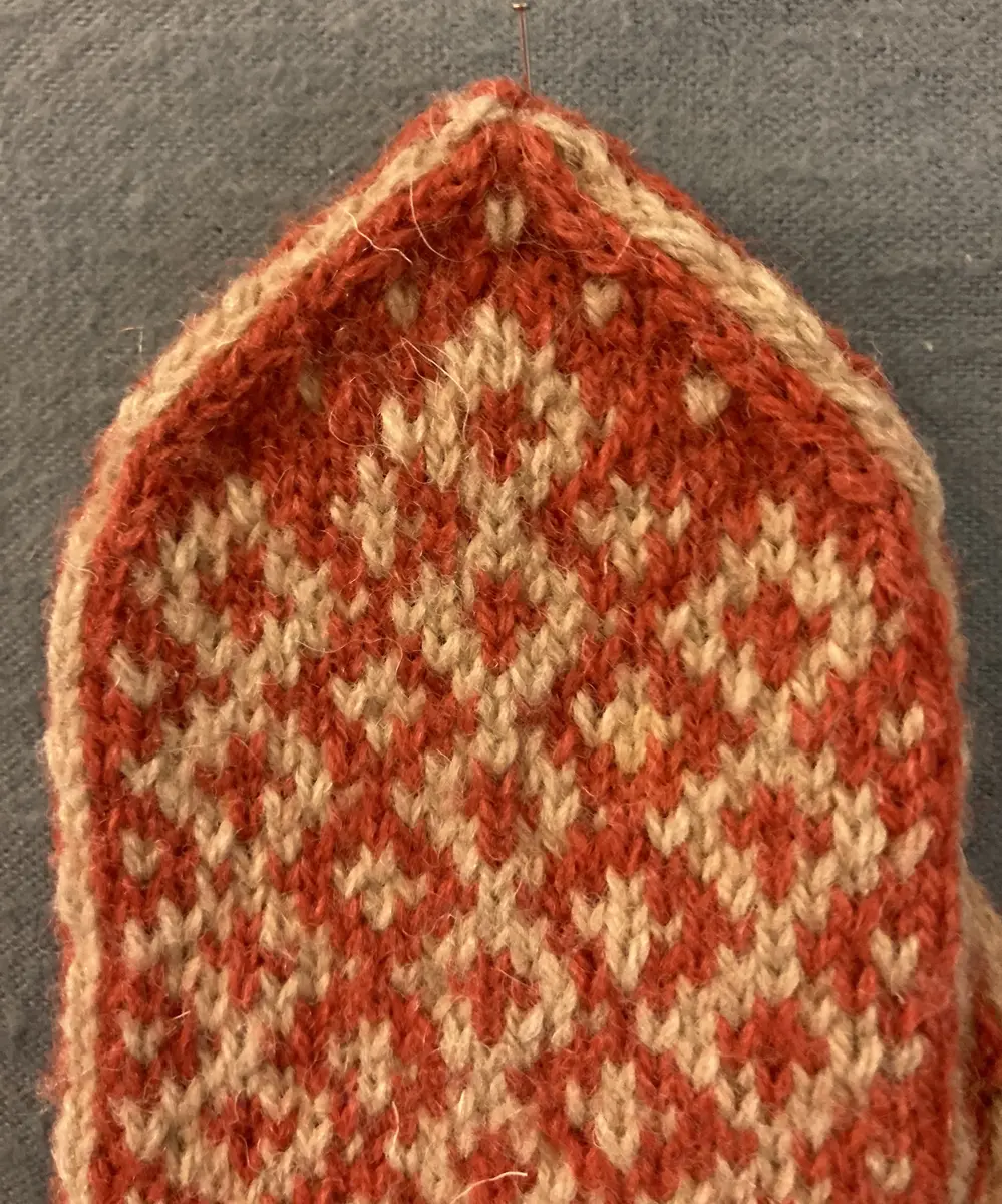 Mönsterstickad barnvante.