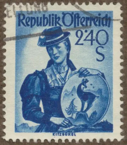Frimärke med motiv av kvinnodräkt från Kitzbuhel. hållandes fat med gems, från Österrike 1951.