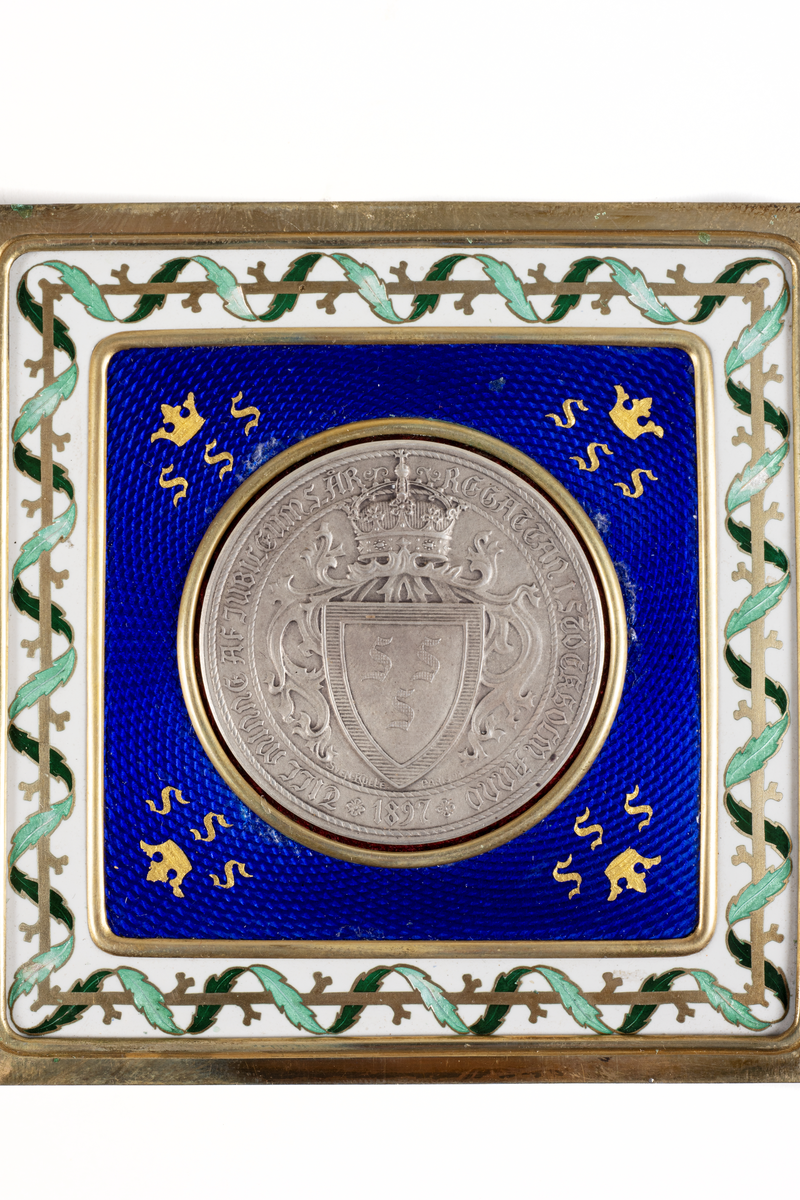 Medalj av silver från Svenska Segelsällskapets jubileumsregatta 1897. På åtsidan kung Oskar II i bröstbild i relief inom stiliserad krans. Frånsidan visar en krönt sköld med "SSS".