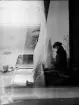 Dubbelexponerad - Bostadsinteriör/ Kvinna sitter vid Gunillaklockan , Uppsala, Uppland