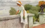 Vykort med motiv av en kvinna sittande på stenmur. Text på baksidan med födelsedagshälsning.