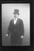 Porträtt av en okänd man med mustasch, hög hatt och spatserkäpp.
