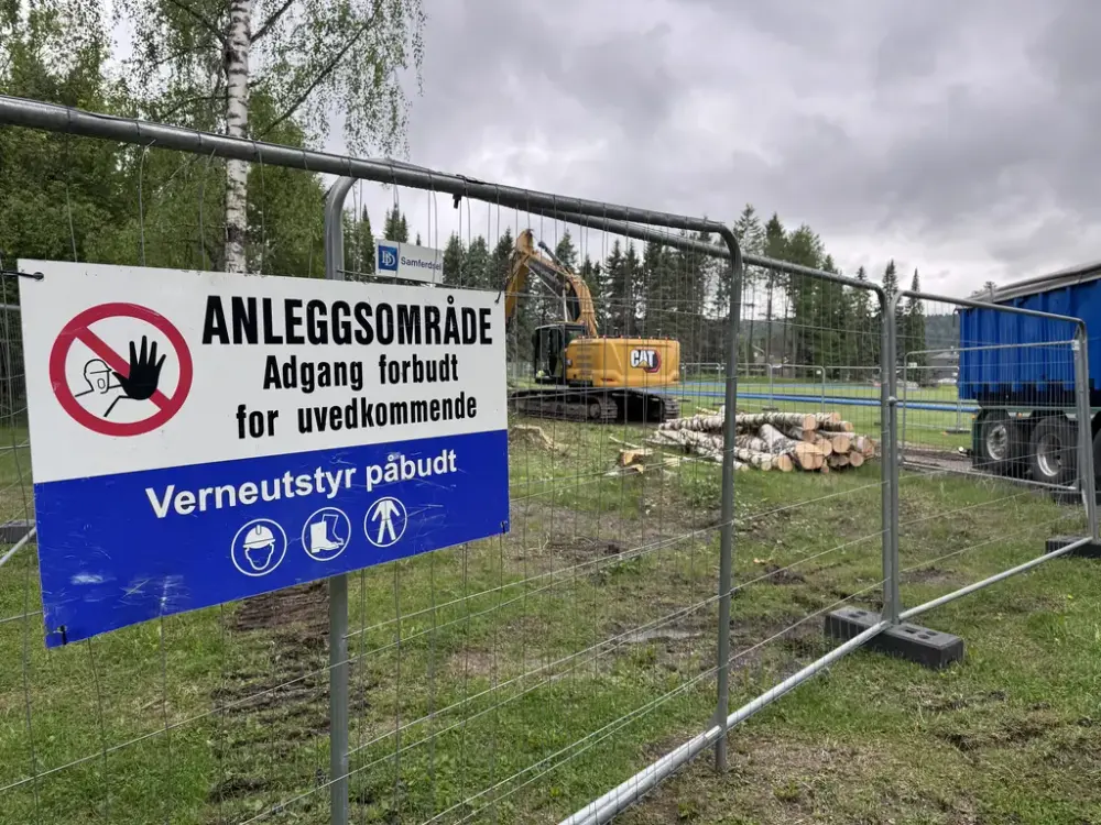 Anleggområde med gravemaskin og gjerder