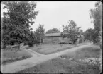 Fotografi i serie för identifiering av motiv ur A C Hultgrens fotosamling.

Kommentar:
Uthus invid gård.
