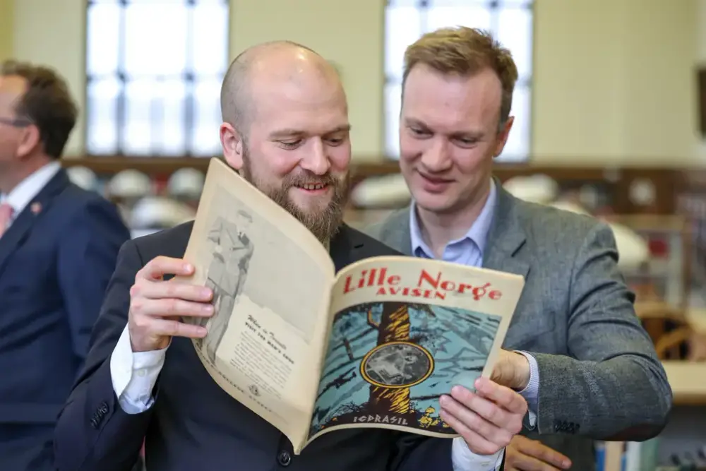 The Norwegian Storting/Parliament on the Saint Olaf College campus. The photo (L-R) shows Willfred Nordlund and Bård Ludvig Thorheim looking at Lille Norge Avisen which was part of NAHA’s Camp Little Norway Association collection digitized for the association’s World War II digitization project. 