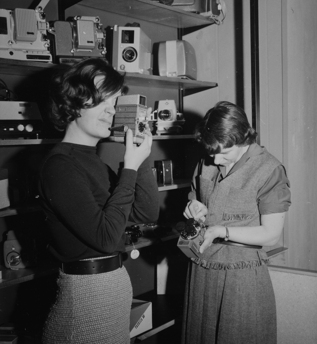 Hamar, Torggata 13, firma Fotograf Carl Normann, dugnad av de ansatte for oppussing av fotobutikken, ansatte Eva Bye og Randi Fossum med filmopptakere og fremvisere,
