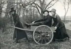 Systrarna Blenda och Ruth Svensson (?) hjälps åt med en kärra, med deras bror Yngve som passagerare.